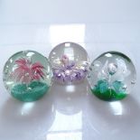 A collection on coloured glass paperweights, tallest 11cm