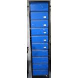 A large painted metal industrial cabinet, with 10 fall-front compartments, W46cm, H198cm