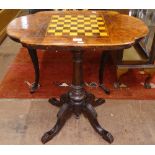 A Victorian walnut games-top table, on turned centre column and carved sabre leg base, W70cm