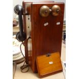 A Vintage wall-mounted oak crank box telephone, with Bakelite Siemens handset and full interior