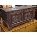 An 18th century joined oak coffer, with chip carved panelled front, on stile legs, W103cm