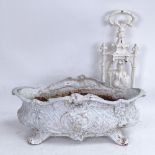 A 19th century white painted cast-iron jardiniere, and a similar cast-iron knight doorstop,