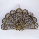 A Victorian brass peacock fire screen, overall height 62cm