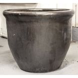 A large circular black glazed planter, H48cm