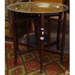 A Chinese heavy hardwood brass-top plantation table on folding base, W63cm