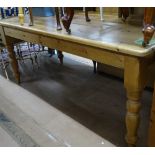 A rectangular pine kitchen table, with end frieze drawer, on baluster turned legs, L173cm