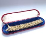 A stylised gilt-metal woven bracelet with ball drops, in original fitted leather case