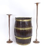 A brass-bound barrel-shaped bucket, and a graduated pair of Arts and Crafts style candlesticks (3)
