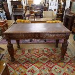 A Victorian Carolean style oak library writing table, with frieze drawers, inset leather top on