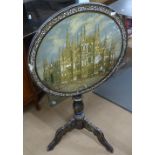 19th century Continental black lacquered tilt-top table, the top having a painted cathedral scene,
