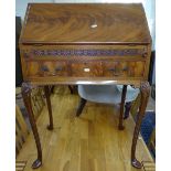 A 1930s lady's walnut writing bureau, with single drawer, raised on shell carved cabriole legs,