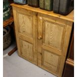 A pine side cabinet with 2 panelled doors, W82cm, H94cm