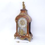 A large reproduction Louis XIV style mantel clock, ornate marquetry inlay with brass mounts, with