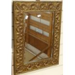 A brass-framed bevel-edge wall mirror, relief shell decoration, overall height 56cm