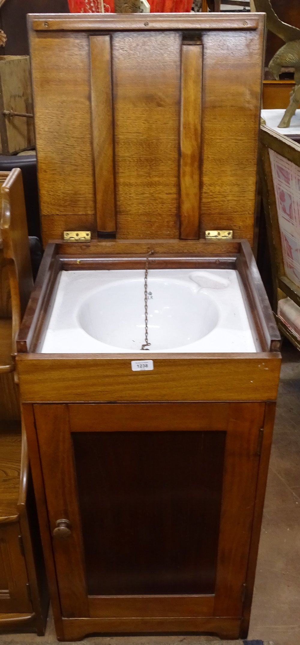 A mahogany campaign washstand, the rising lid revealing an enamel sink with cupboard under, W48cm