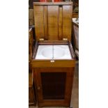 A mahogany campaign washstand, the rising lid revealing an enamel sink with cupboard under, W48cm