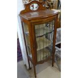 A late Victorian mahogany and satinwood-strung bow-front display cabinet, with leadlight glazed