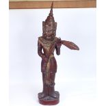 A large Burmese carved lacquered and gilded wood Nat figure on plinth, overall height 93cm
