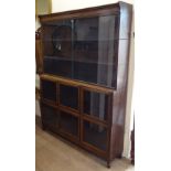 An early 20th century Minty 5-section oak bookcase, with glazed cupboards and sliding doors, W133cm,