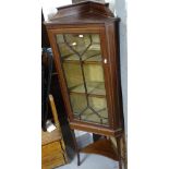 An Edwardian mahogany and satinwood-strung corner display cabinet, with single lattice-glazed