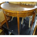 A 19th century mahogany demilune fold over card table, with marquetry decoration, raised on square