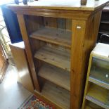 A polished pine floor standing open bookcase, of narrow size, W80cm