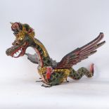 An Oriental carved and painted wood sectional hanging dragon sculpture, length 67cm