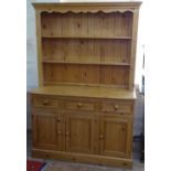 A modern polished pine 2-section kitchen dresser, base fitted with drawers and cupboards, W133cm