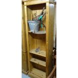 A narrow polished pine floor standing open bookcase, W60cm, H198cm