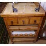 A pine and tile-top butcher's block, with fitted drawers, shelf and wine rack under, W67cm