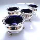A set of 4 silver salts with shaped edge and Bristol blue liners