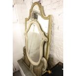 A French cream painted wall mirror, with bergere panels of shaped form, and a shield-shaped