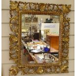 A 19th century giltwood-framed wall mirror, floral surround, overall height 54cm