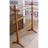 An Arts and Crafts walnut inlaid towel rail, W76cm