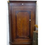 A Georgian oak and mahogany hanging corner cupboard, and a Georgian mahogany hanging corner cupboard