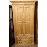 A modern polished and panelled pine 2-door wardrobe, with 2 drawers to the base, W99cm