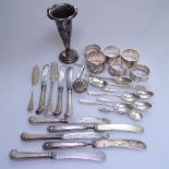 A tray of silver items, to include 6 napkin rings, a Georgian bright-cut teaspoon, a set of 5 silver