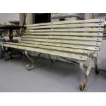A scrolled wrought-iron and slatted garden bench, L180cm