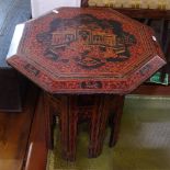 An Oriental red and black lacquered octagonal occasional table, with ceremony decorated top, W46cm