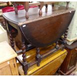 An oak oval gateleg table on barley twist legs, W89cm