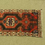 A Persian design red and blue ground rug