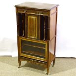 An Edwardian mahogany music cabinet by Edwards & Roberts, with blind fret decoration and glazed