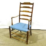 An 18th/19th century elm ladder-back elbow chair