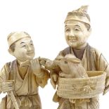 A Japanese sectional ivory carving, depicting 2 men holding a rabbit in a basket, Meiji Period circa