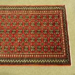 A Persian design red ground geometric design rug