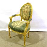 An ornate carved giltwood-framed open arm elbow chair