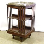 An Edwardian mahogany revolving bookcase with brass galleried top, width 49cm, height excluding