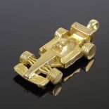 A modern gold plated novelty Formula 1 figural racing car pendant, newly attached 9ct loop,