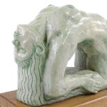 A modern British green glazed ceramic nude female sculpture, unsigned, on oak plinth, plinth