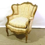 An ornate relief carved giltwood-framed armchair, late 19th/early 20th century, with original floral